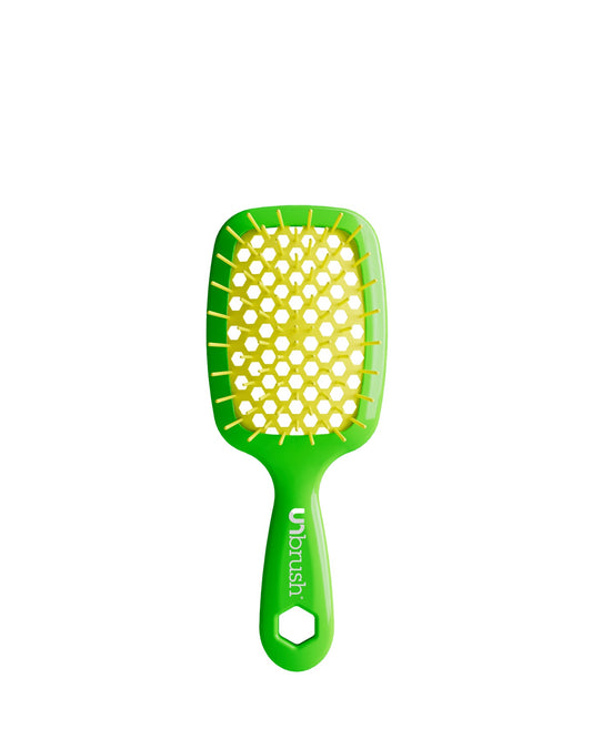 Vibrant Green Unbrush Mini detangling brush with vibrant yellow hexagon bristle pattern, designed for gentle use on wet or dry hair.