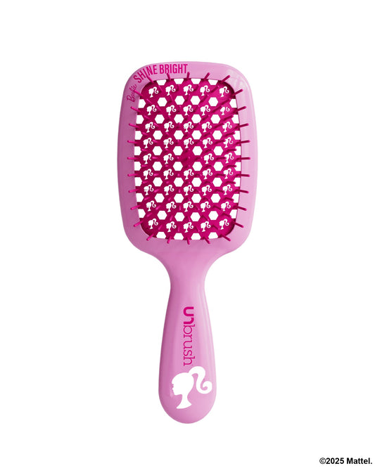 Pink hairbrush with character design on a white background