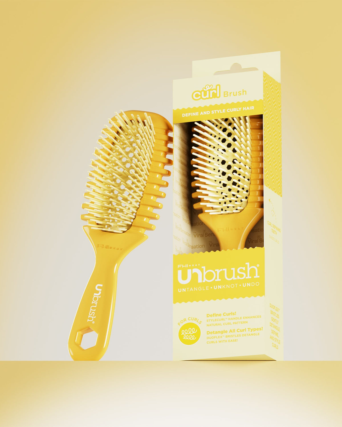 Yellow hairbrush with packaging on a yellow background