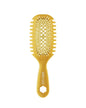 Yellow hairbrush on a white background