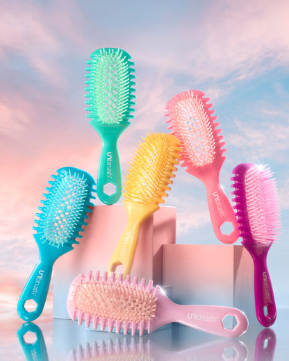 Set of colorful hairbrushes on a gradient background