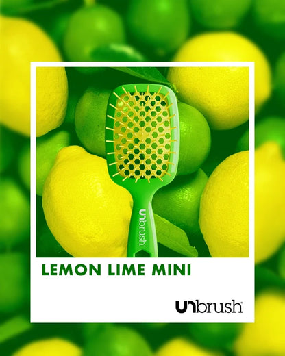 “Lemon LIme” Unbrush Mini with vibrant yellow hexagon bristles and vibrant green handle, styled against light fruit background.